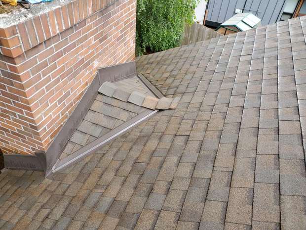 Rebuilt chimney flashing and cricket on a shingle roof in the Greater Eastside, WA