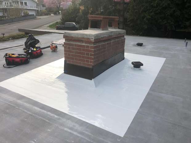 New membrane and chimney flashing on a flat roof in the Greater Eastside, WA