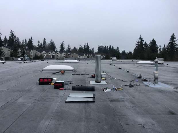Modified bitumen flat roof work in progress on a commercial building in the Greater Eastside, WA