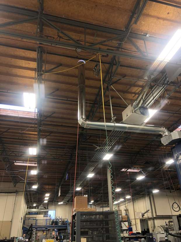 Exhaust duct routed through the roof of an industrial facility in the Puget Sound region, WA