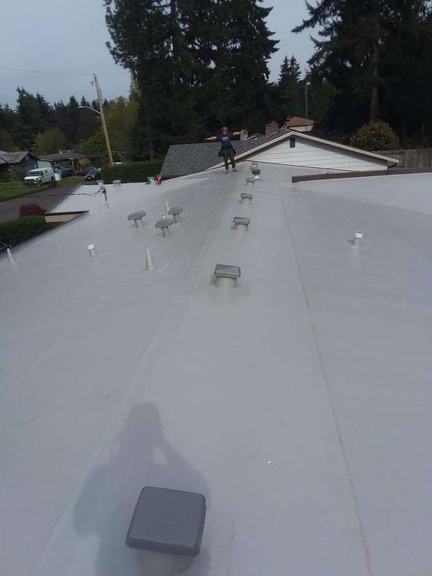 Top Line roofer on a newly installed single-ply membrane roof in the Greater Eastside, WA