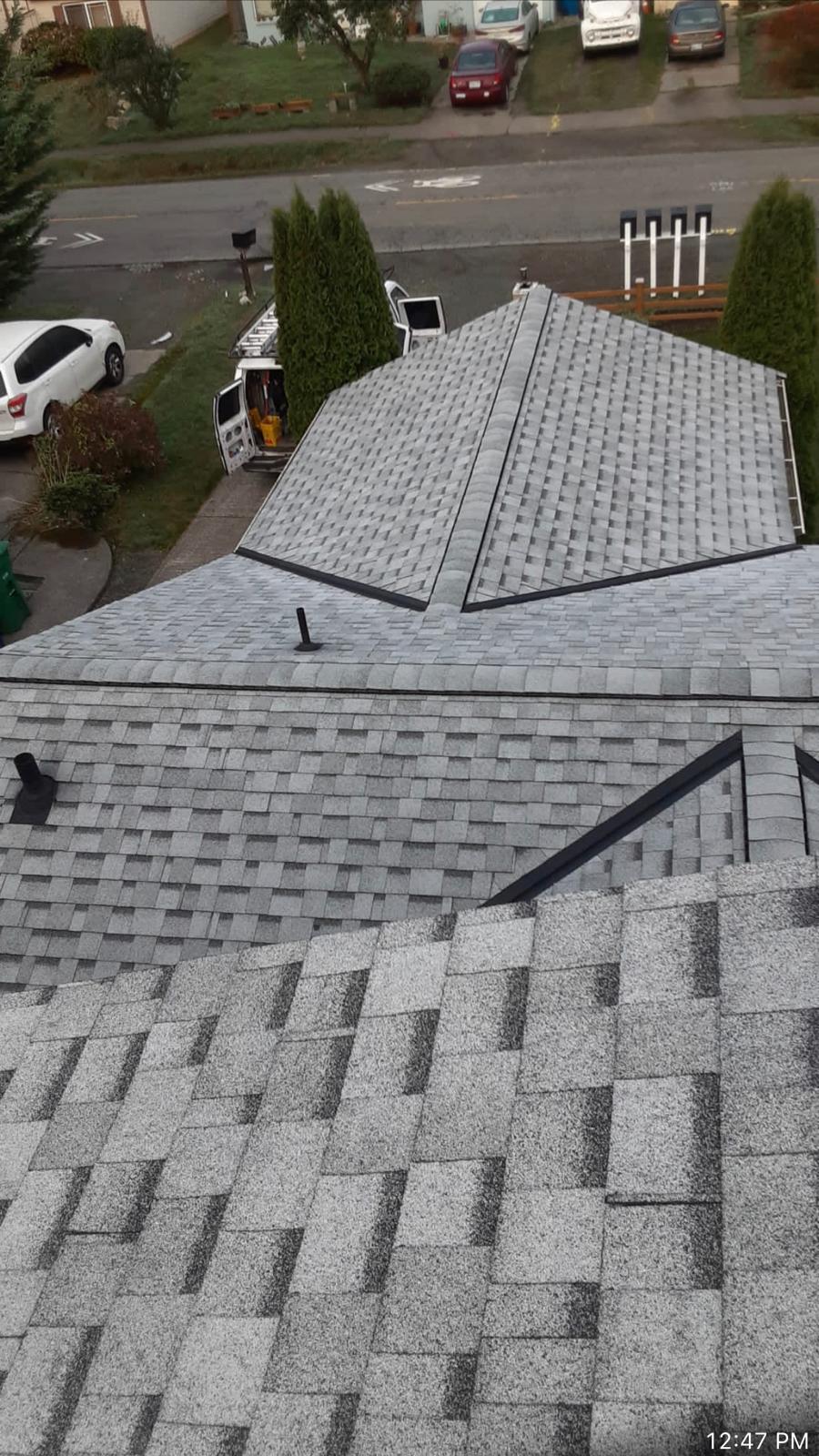 Valley flashing and hip detail on a newly installed shingle roof in the Greater Eastside, WA