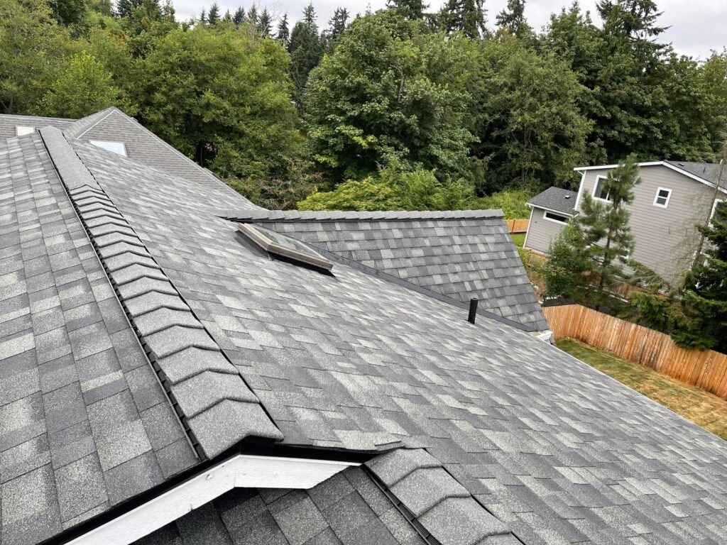 Architectural shingle roof with hip ridges and a skylight on a home in the Greater Eastside, WA