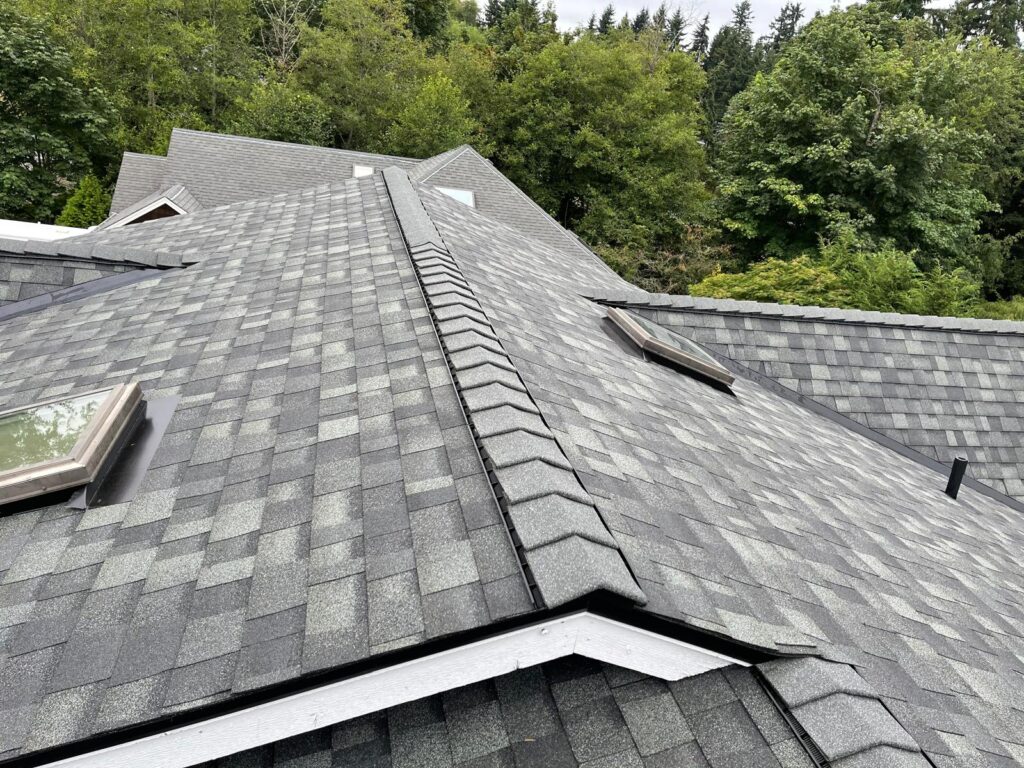 Architectural shingle roof with dormers, skylights and a ridge vent on a home in the Greater Eastside, WA