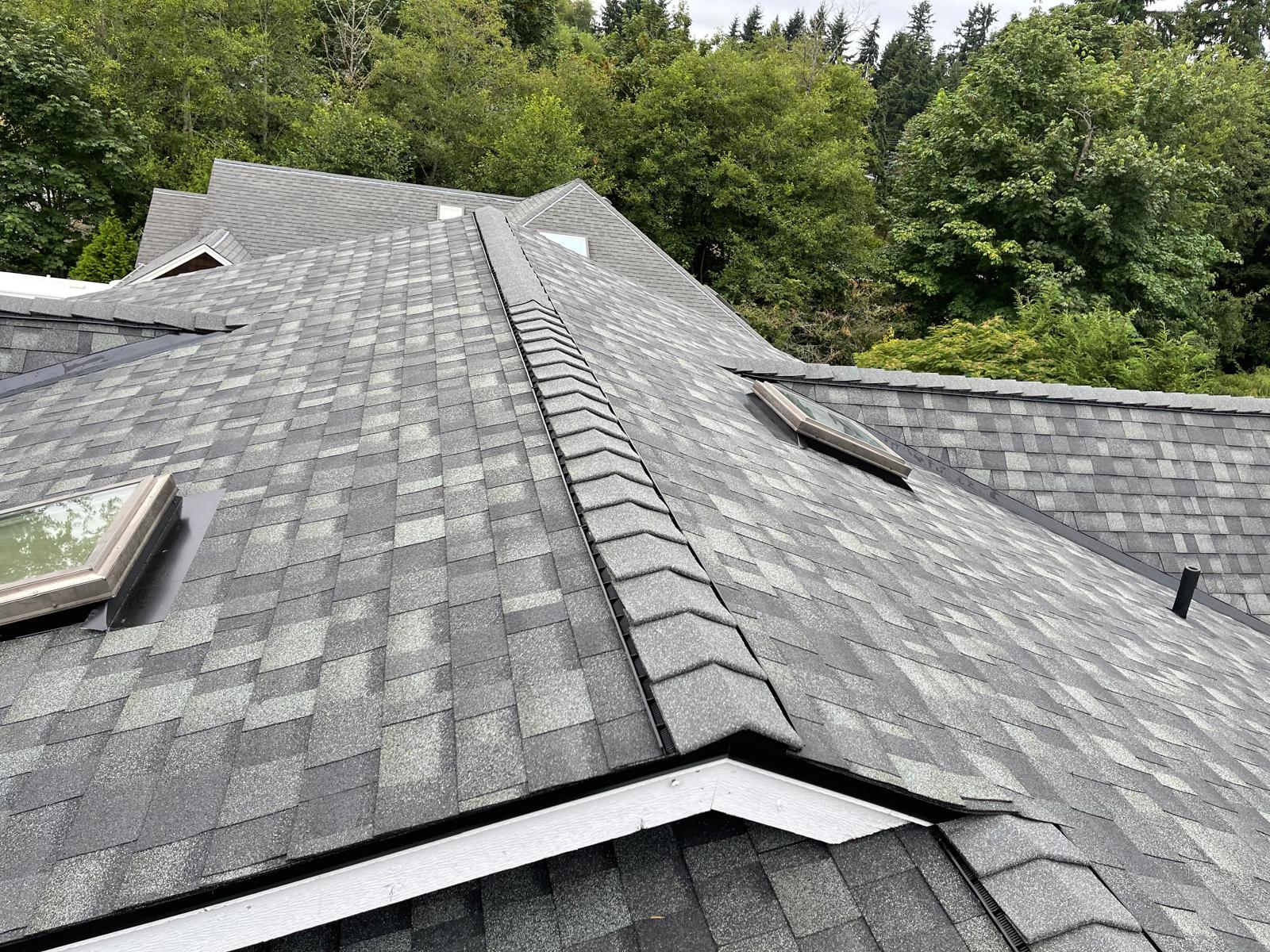 Architectural shingle roof with dormers, skylights and a ridge vent on a home in the Greater Eastside, WA