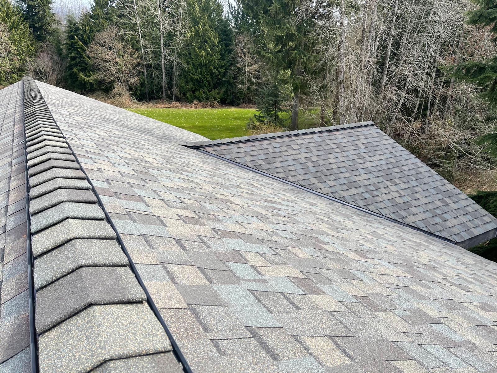 Architectural composition shingle roof with new ridge cap on a home in the Greater Eastside, WA