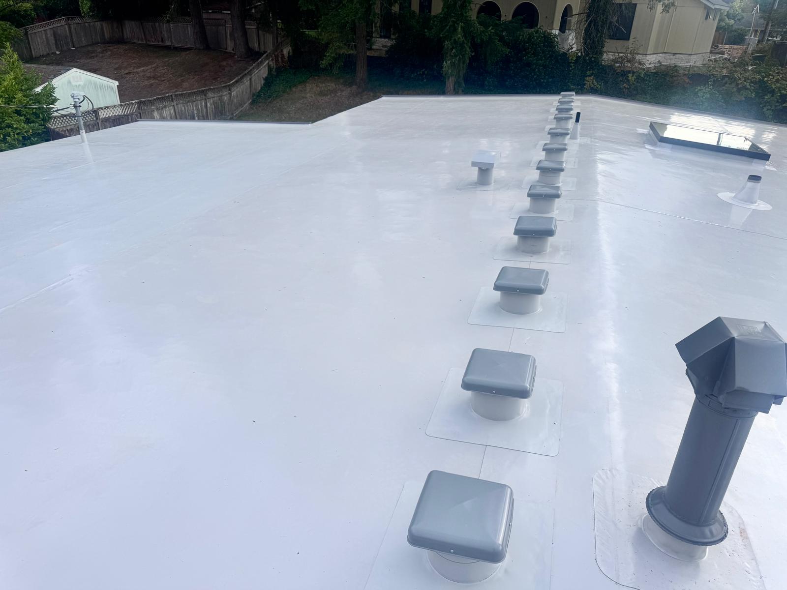 New white PVC membrane roof with vents and a skylight